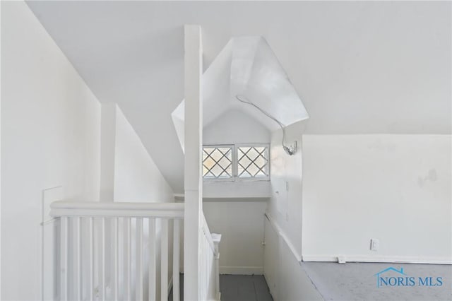 stairway with vaulted ceiling