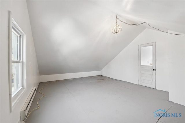 bonus room featuring lofted ceiling, a notable chandelier, and a baseboard radiator