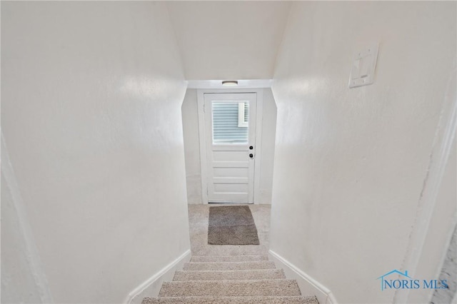 staircase featuring baseboards