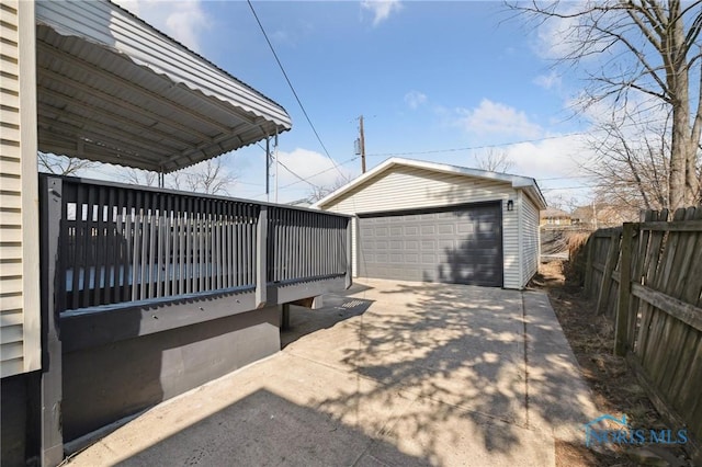 exterior space featuring an outbuilding, a garage, and fence