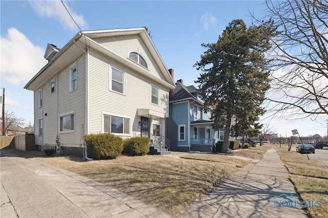 view of front of home featuring fence