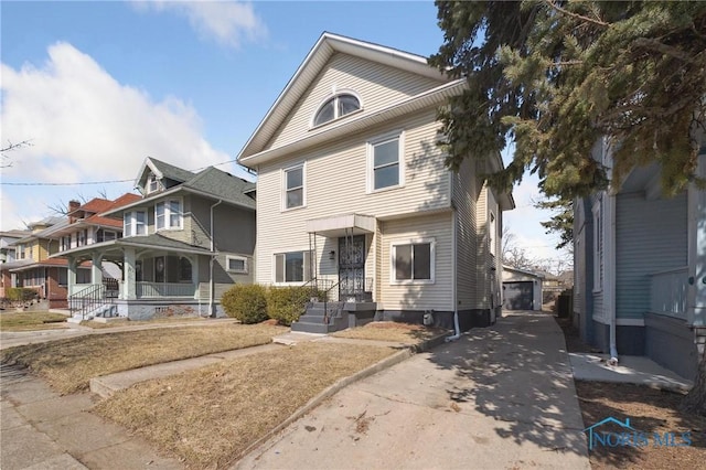 view of front of property featuring an outdoor structure, a porch, and a residential view