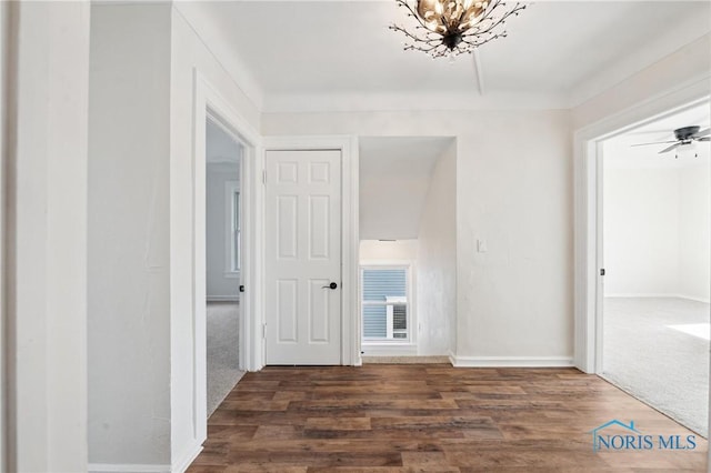 interior space with a notable chandelier and wood finished floors