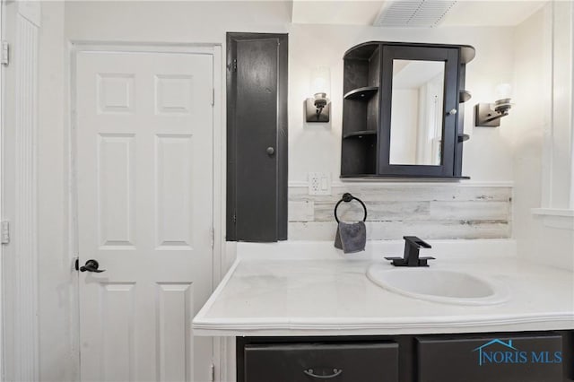 bathroom with vanity and visible vents