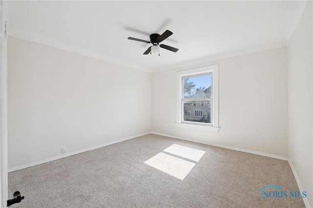 spare room featuring a ceiling fan, baseboards, and carpet floors