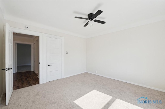 unfurnished room featuring ceiling fan and carpet floors