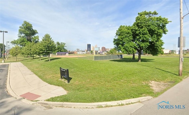 view of home's community featuring a view of city and a lawn