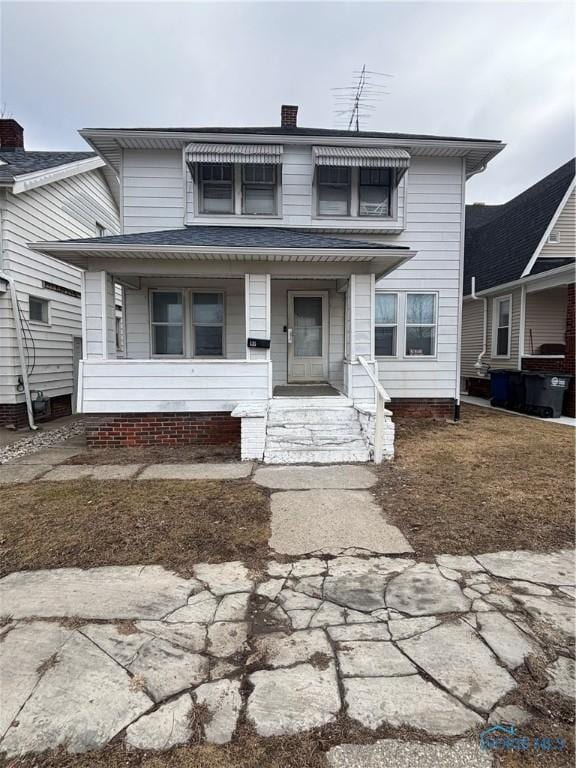 view of front of home with a porch and a chimney