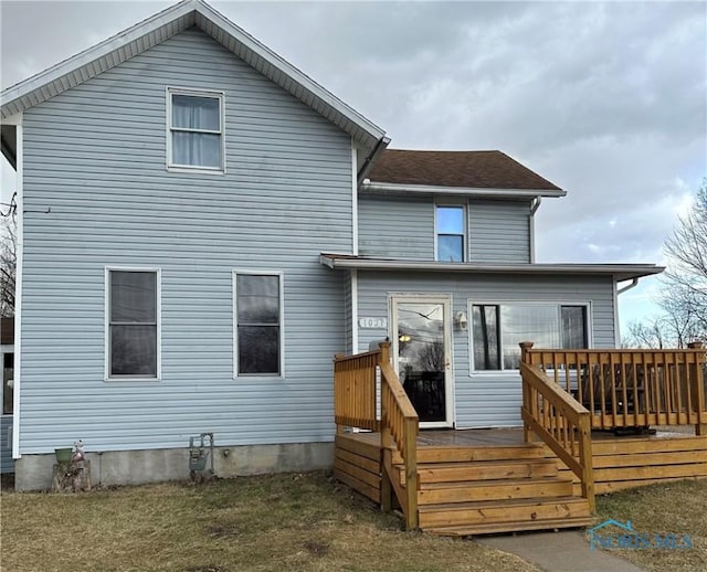 back of property featuring a wooden deck