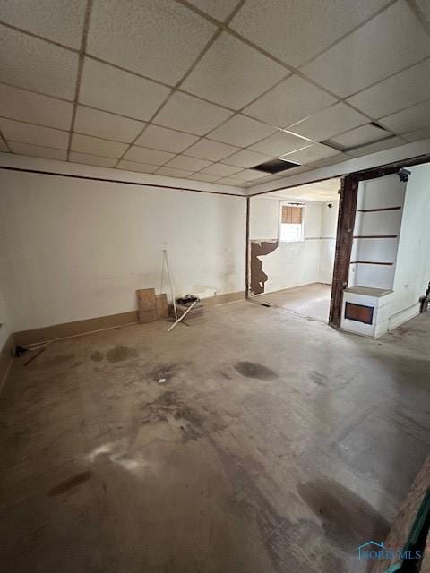 basement with a paneled ceiling