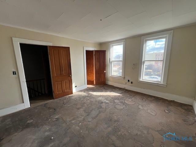 unfurnished bedroom with baseboards