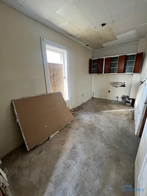 kitchen with open shelves and concrete flooring