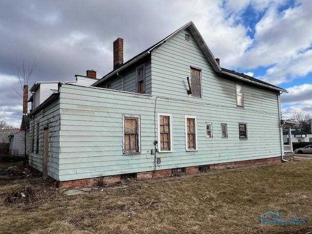 rear view of property with a chimney