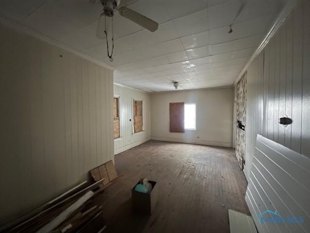 spare room with crown molding, a ceiling fan, and hardwood / wood-style floors