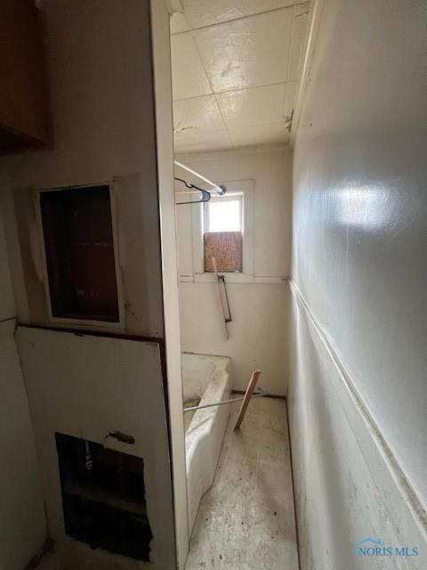 bathroom with a washtub and walk in shower