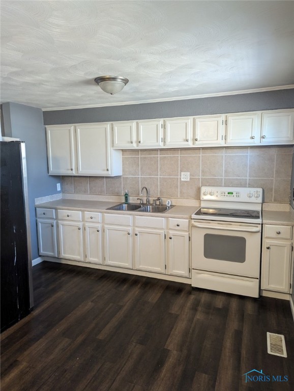 kitchen featuring dark wood-style flooring, a sink, light countertops, electric stove, and backsplash