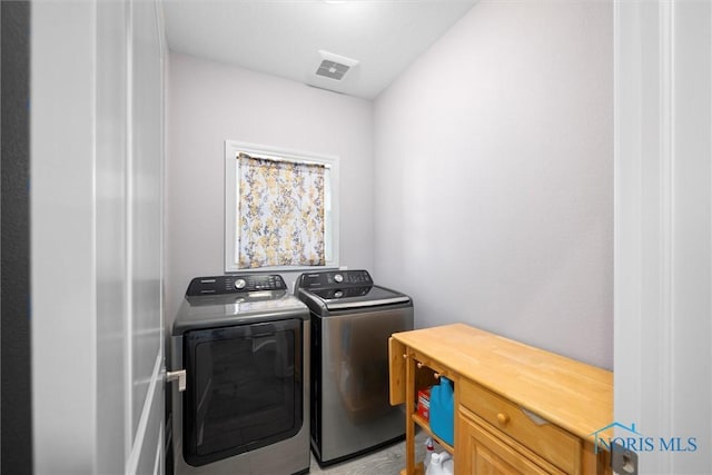 laundry room featuring washer and clothes dryer, laundry area, and visible vents