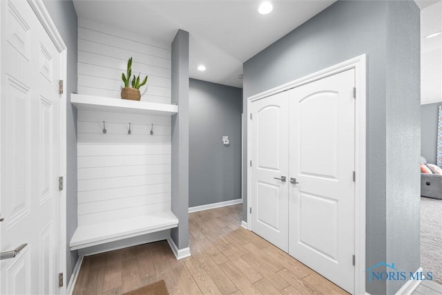 mudroom featuring recessed lighting, light wood-type flooring, and baseboards