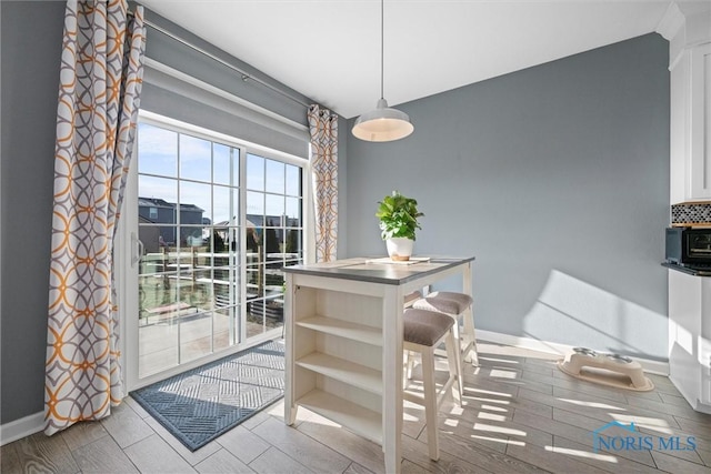 dining area featuring baseboards