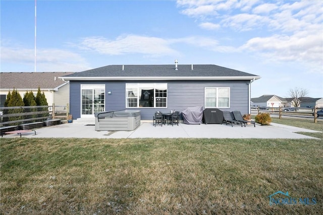 back of house featuring a patio, fence, and a hot tub