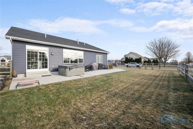 back of house with a patio, a lawn, and fence