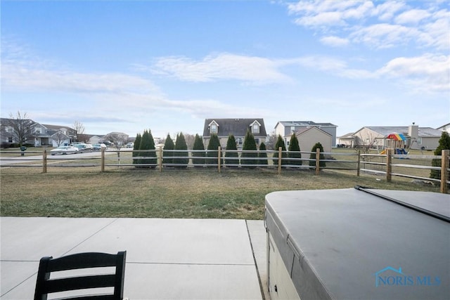 exterior space featuring a patio, fence, and a residential view