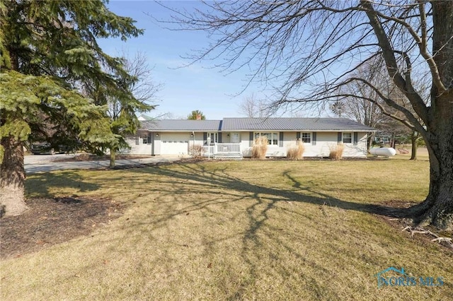 ranch-style home featuring a garage and a front yard