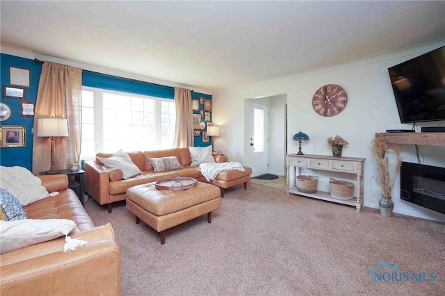 living room featuring carpet flooring, a fireplace, and baseboards