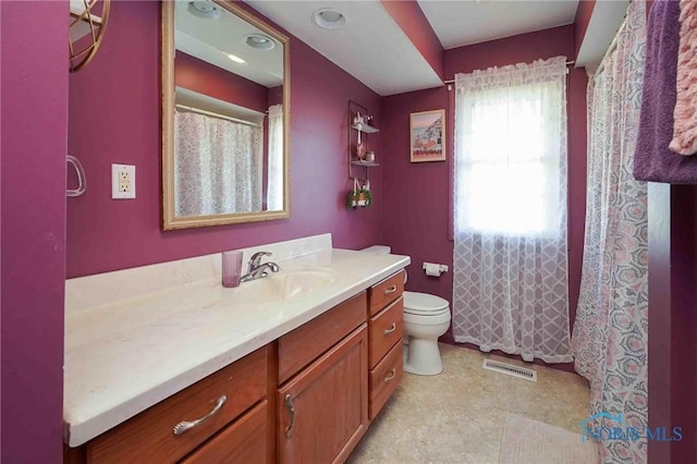 bathroom with visible vents, toilet, and vanity