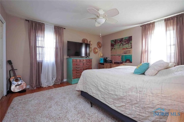 bedroom featuring a ceiling fan and wood finished floors