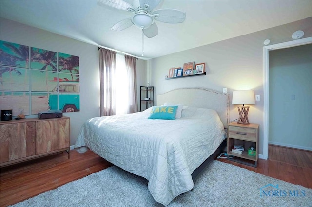 bedroom with baseboards, a ceiling fan, and wood finished floors