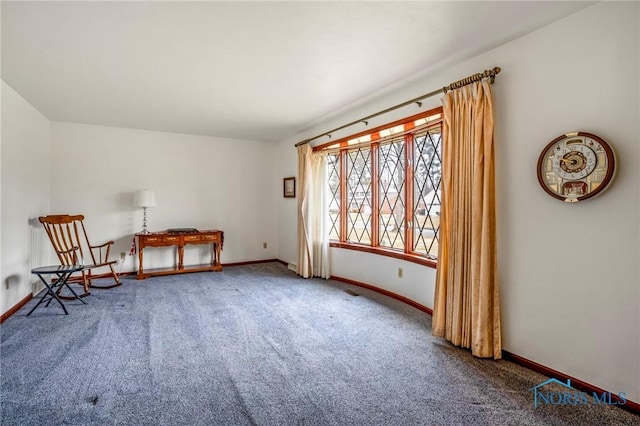 unfurnished room featuring carpet flooring and baseboards