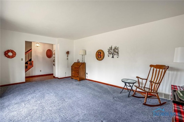 sitting room with stairway, baseboards, and carpet