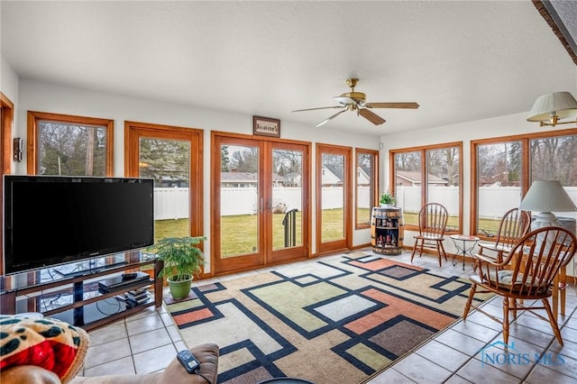 sunroom / solarium with french doors and ceiling fan