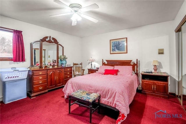 bedroom with dark carpet and ceiling fan