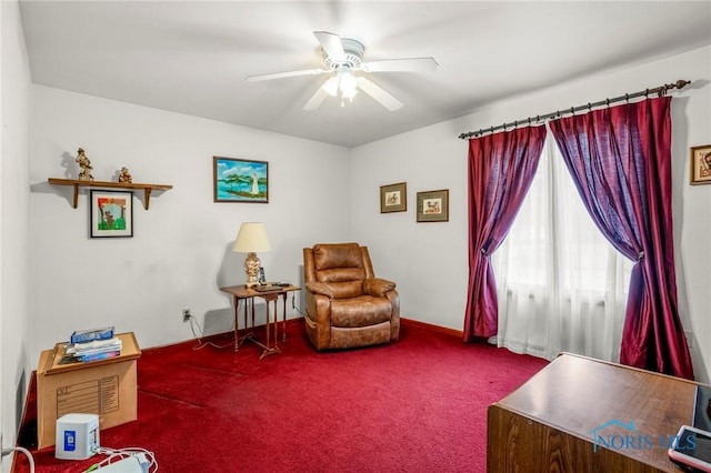 sitting room featuring carpet and a ceiling fan