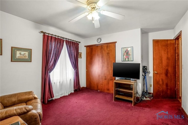 living room with a ceiling fan and carpet floors