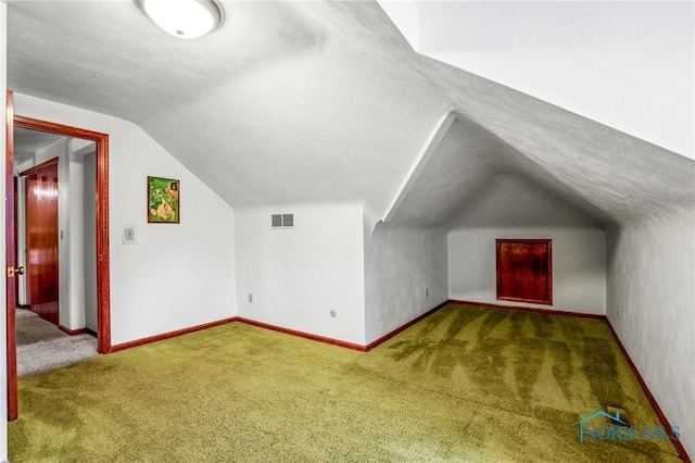 bonus room featuring baseboards, carpet floors, and vaulted ceiling