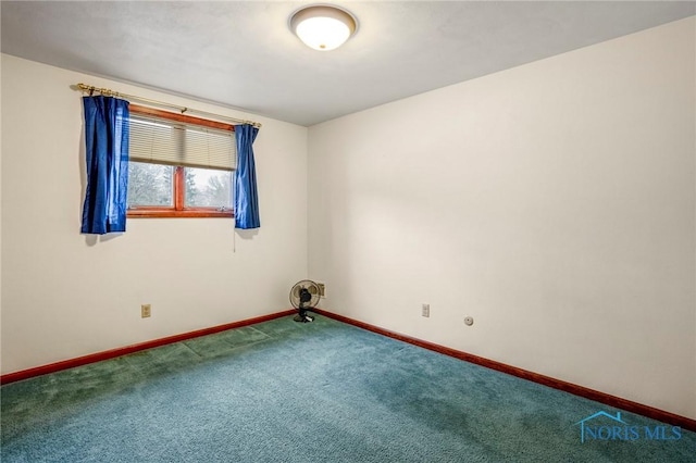 carpeted spare room with baseboards