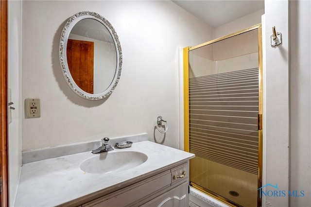 bathroom with a stall shower and vanity