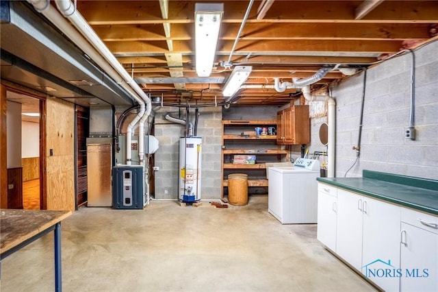 unfinished below grade area featuring heating unit, gas water heater, and separate washer and dryer