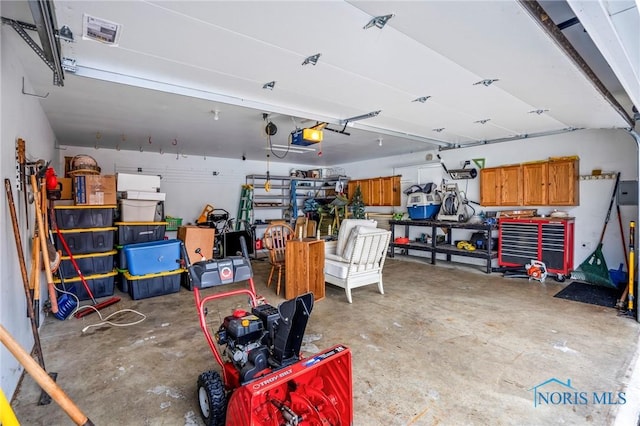 garage featuring visible vents and a garage door opener