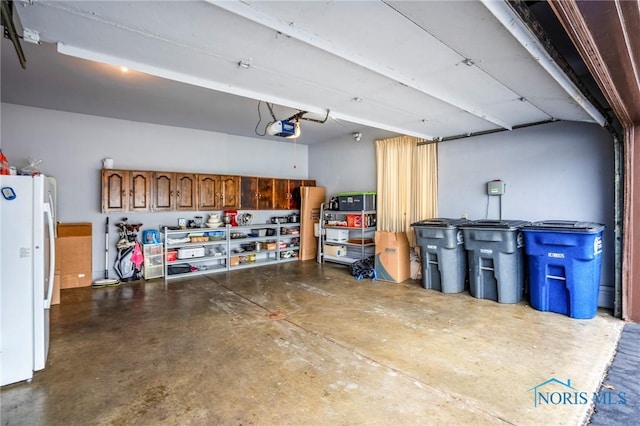 garage with a garage door opener and freestanding refrigerator