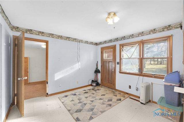 entryway featuring baseboards and light floors