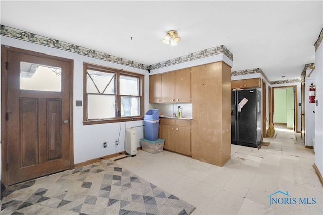 entryway featuring light floors and baseboards