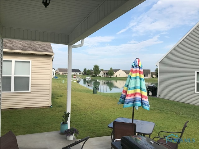 exterior space with a water view and area for grilling