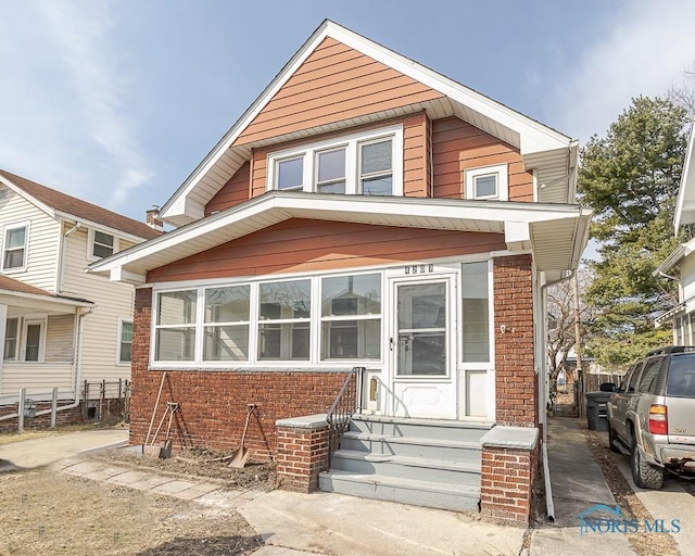 view of front of house with fence and brick siding