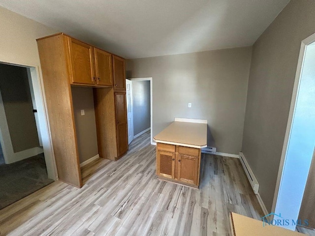 kitchen featuring light wood-style flooring, baseboards, brown cabinets, and a baseboard radiator