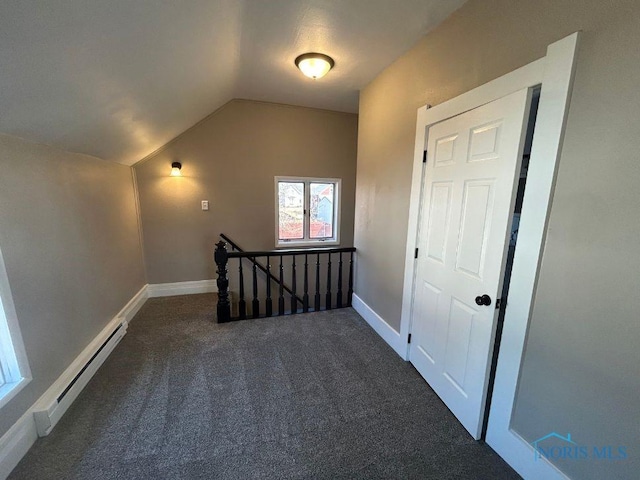 additional living space featuring vaulted ceiling, carpet flooring, baseboards, and a baseboard radiator