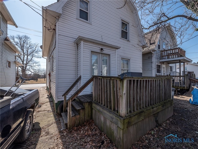 rear view of property featuring a deck